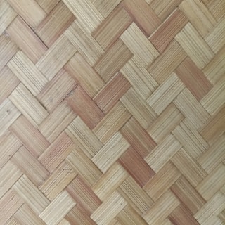 A detailed pattern of interwoven strips creating a textured, basket-like surface. The natural fibers have varying shades of beige and brown, highlighting the woven craftsmanship.