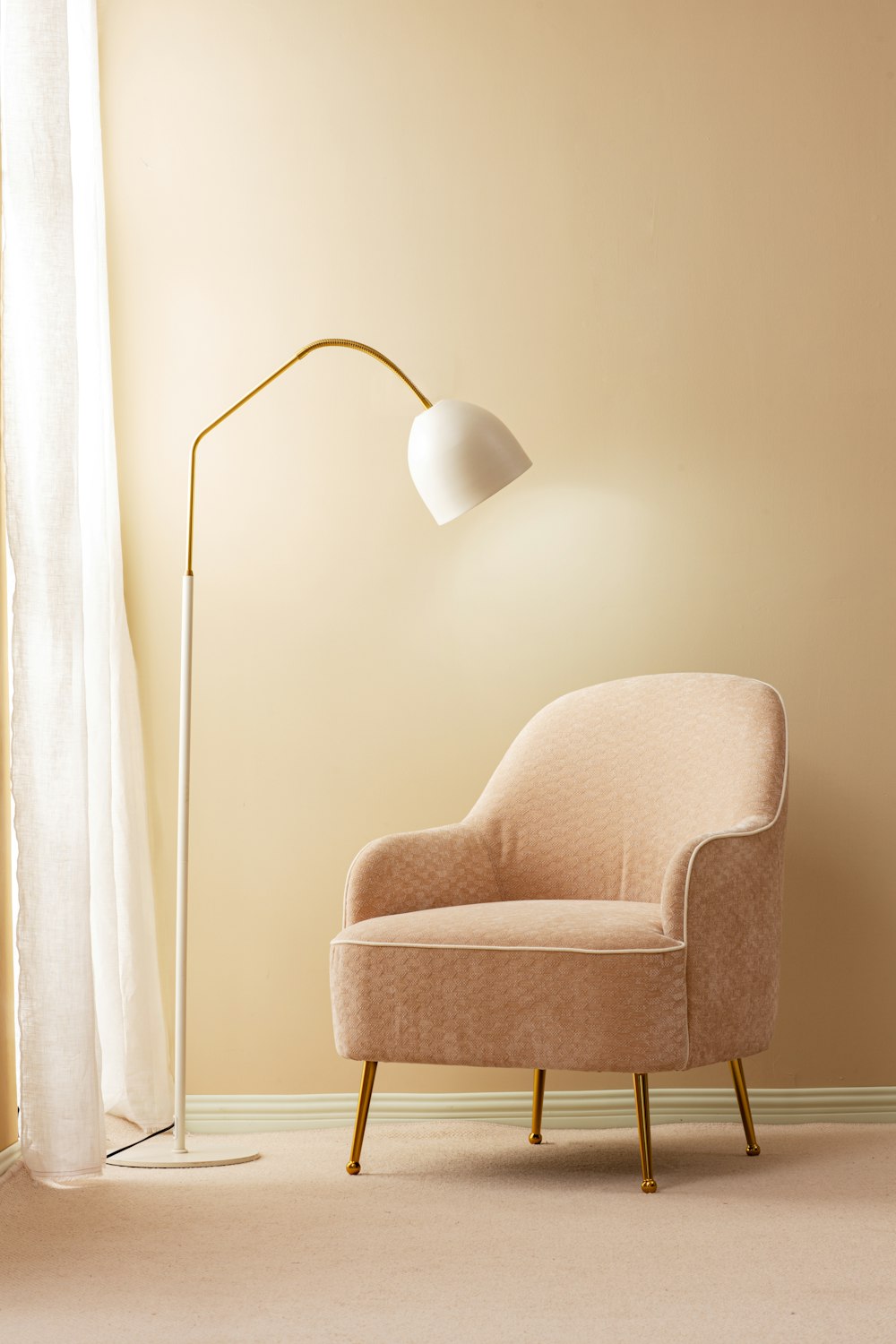 a living room with a chair and a floor lamp
