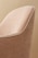 A close-up view of a fabric-covered chair with a textured pattern in shades of beige. The chair features white piping along the edges, creating a clean and elegant outline.