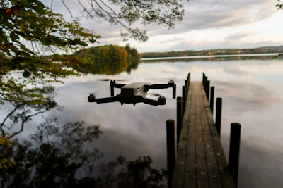 Close-up of a drone capturing footage above a calm freshwater lake