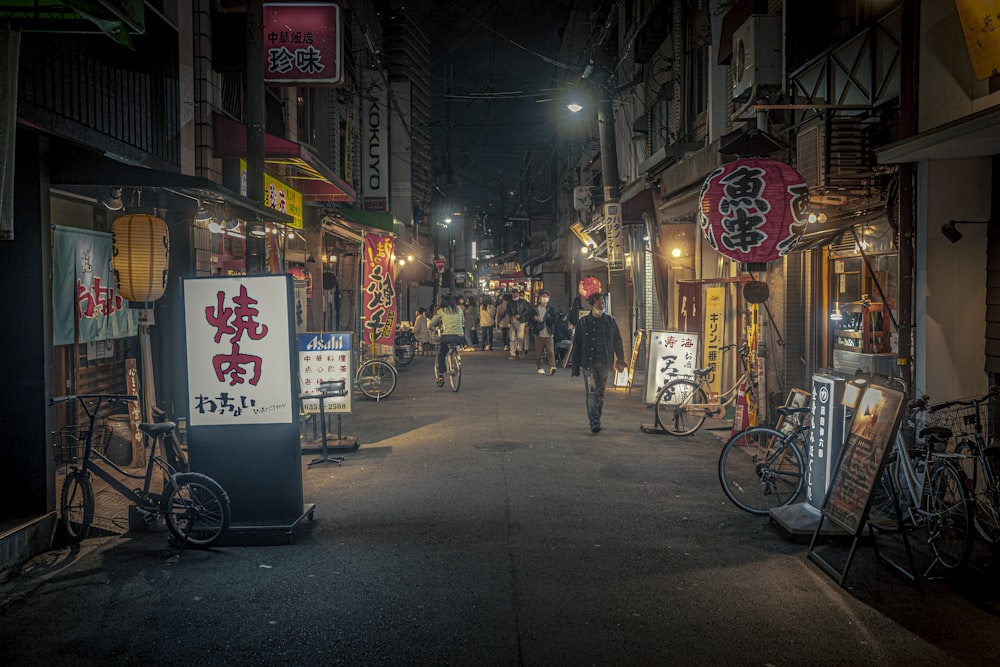 a man walking down a street at night