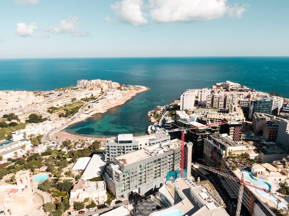 an aerial view of a city next to the ocean