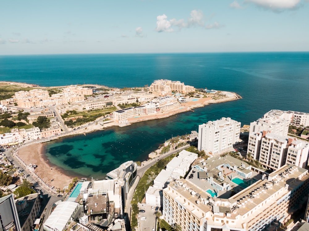 an aerial view of a city next to the ocean