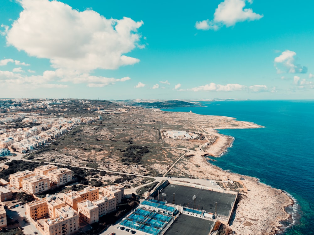 an aerial view of a city next to the ocean