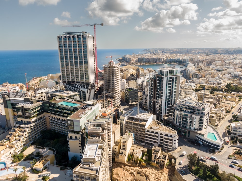 an aerial view of a city next to the ocean