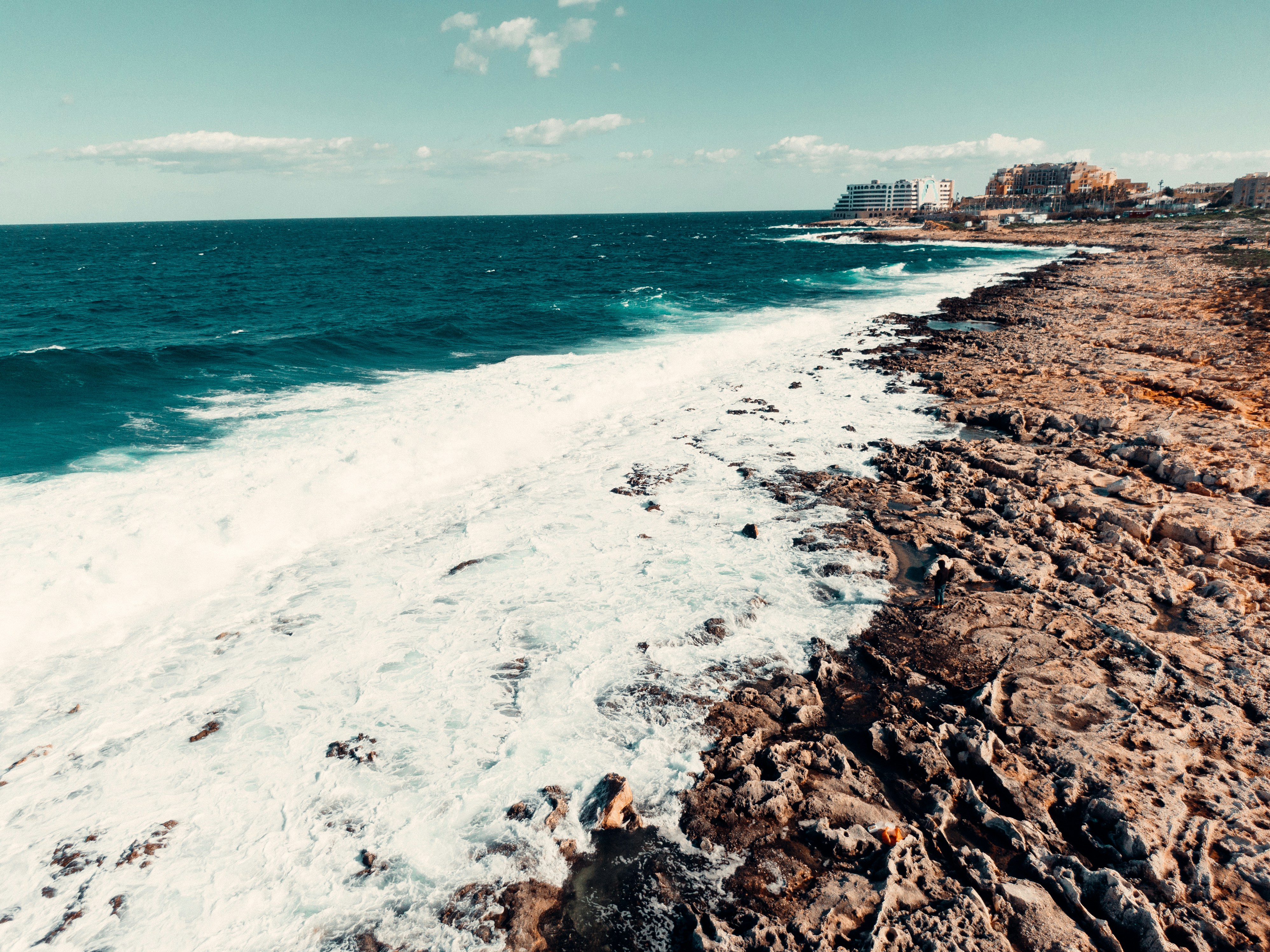 a view of the ocean from a rocky shore, A coast with high waves Malta.