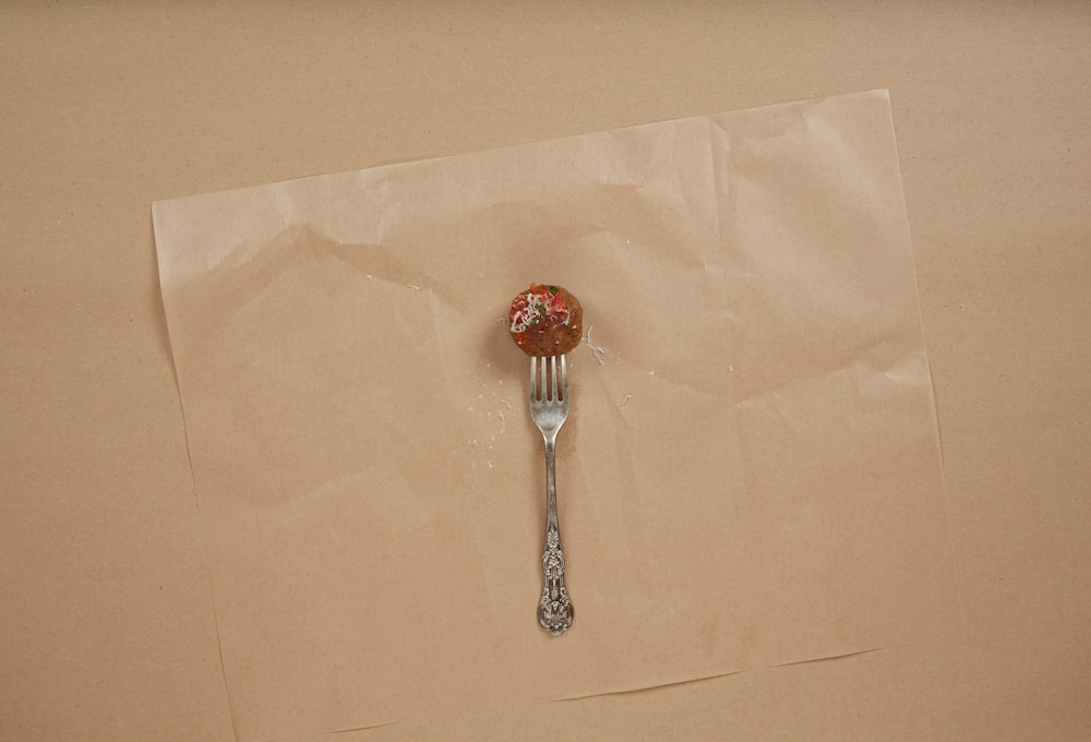 a piece of paper with a fork sticking out of it