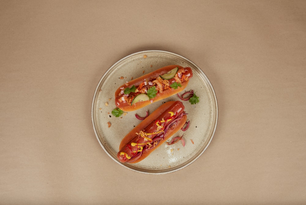 a couple of hot dogs on a plate