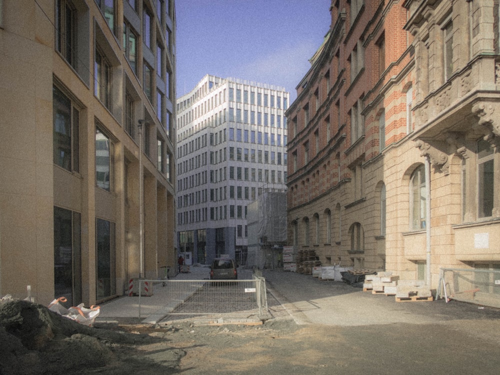 a narrow city street with buildings in the background