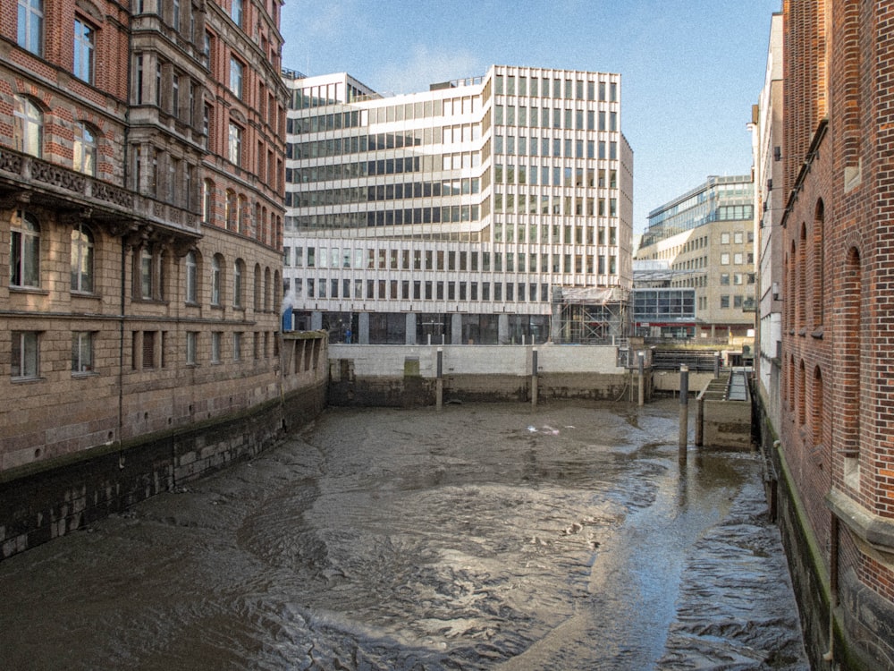 a river running through a city next to tall buildings