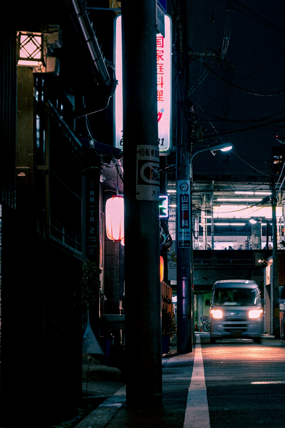 a car driving down a street at night