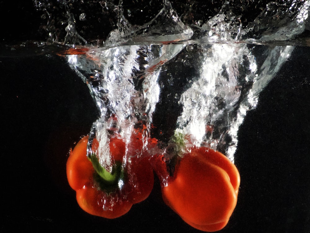 a couple of oranges floating in the water