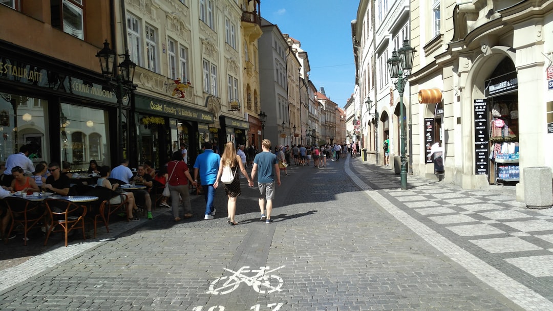a couple of people that are walking down a street,
