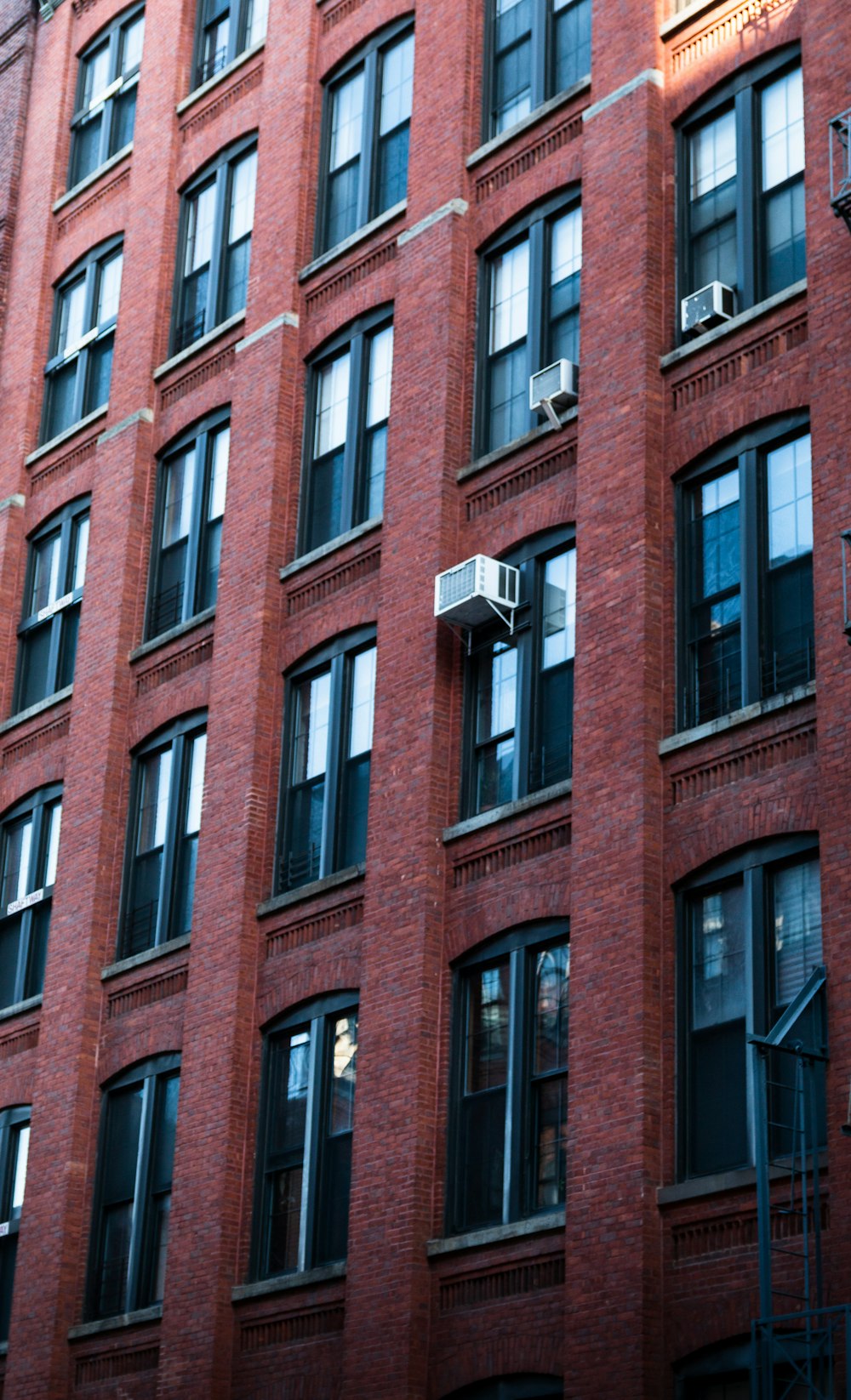 a tall red brick building with lots of windows