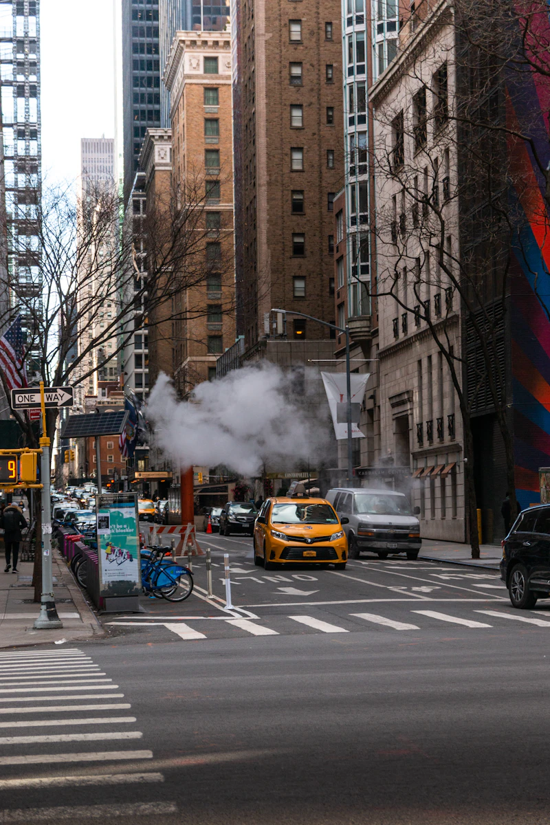 A yellow taxi on a Manhattan street on an overcast day