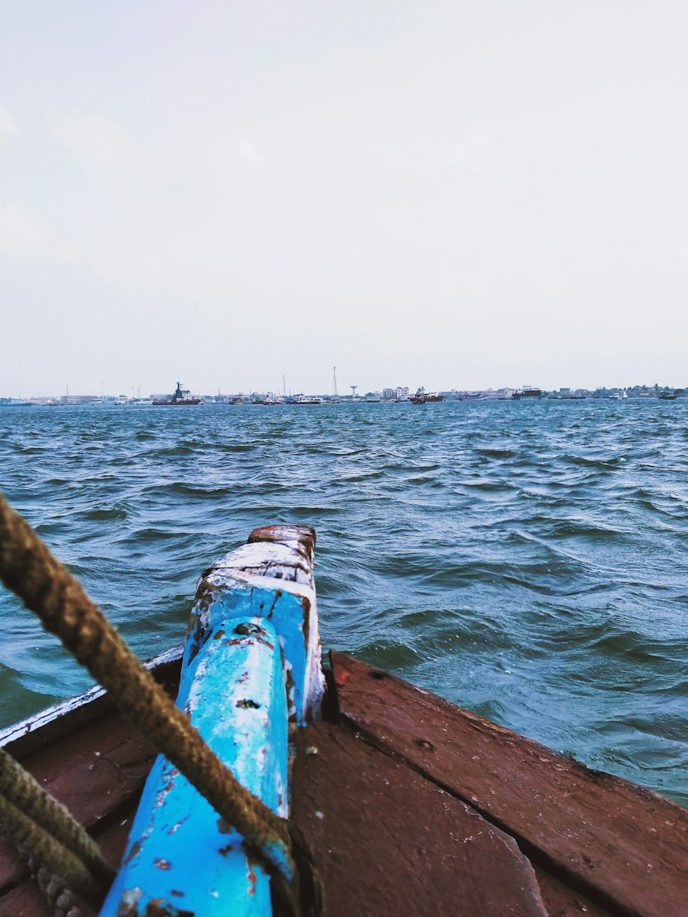 a blue boat in the middle of a body of water