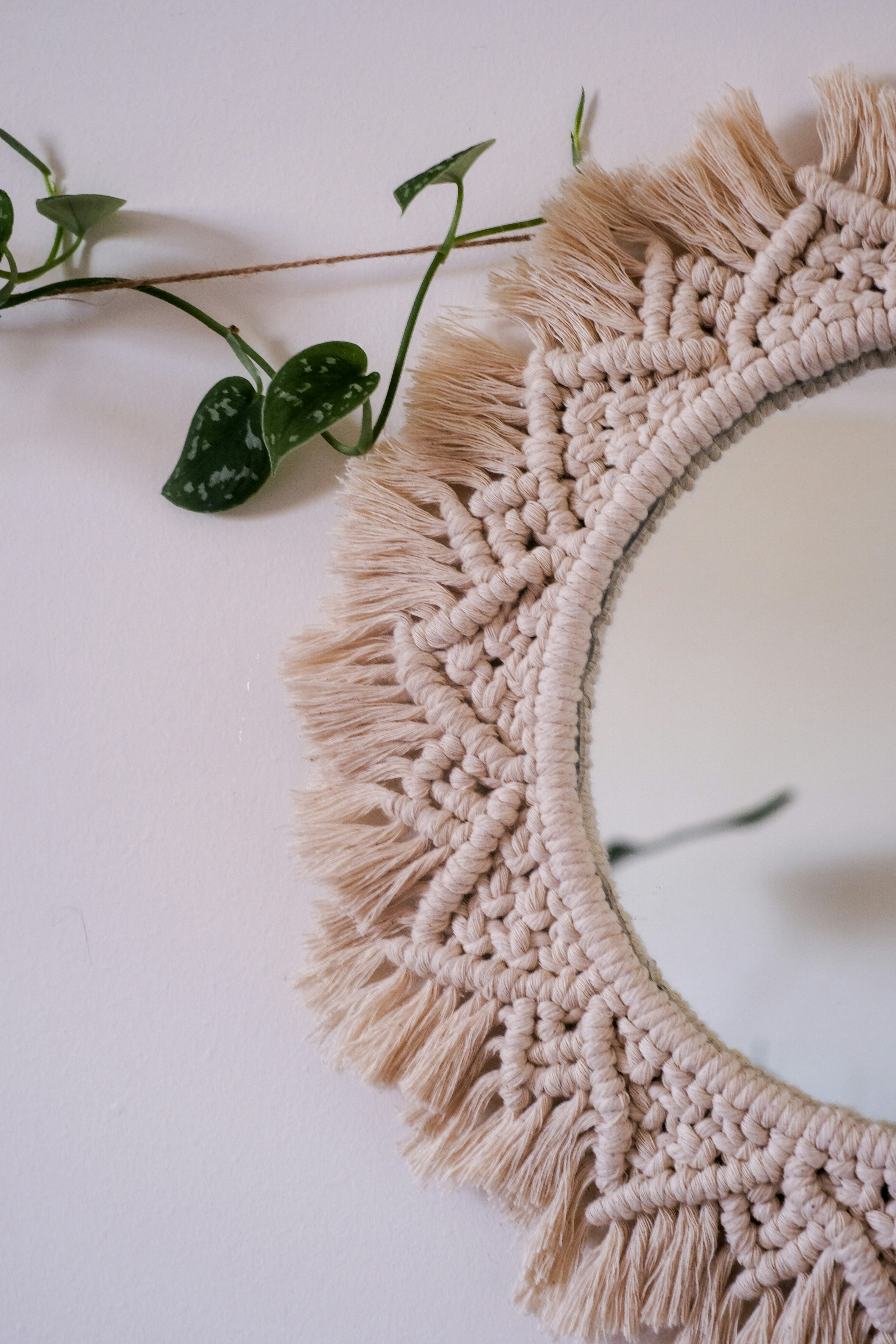 a mirror with a tassel hanging from it