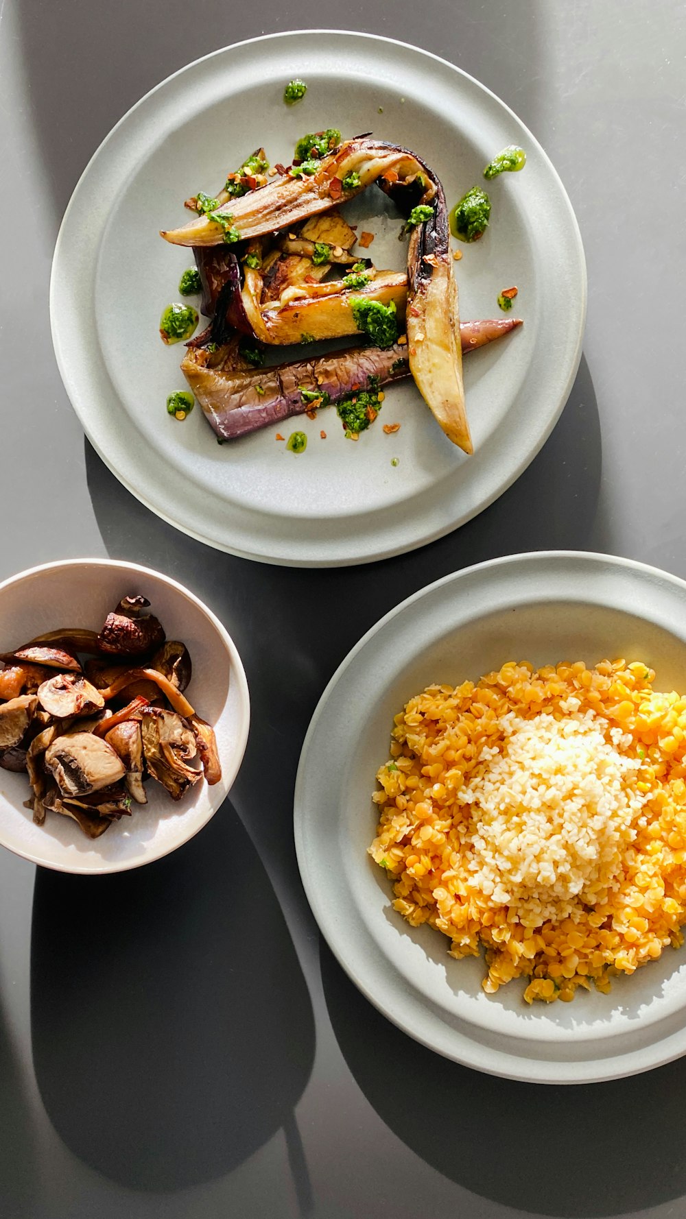 a table with three plates of food on it