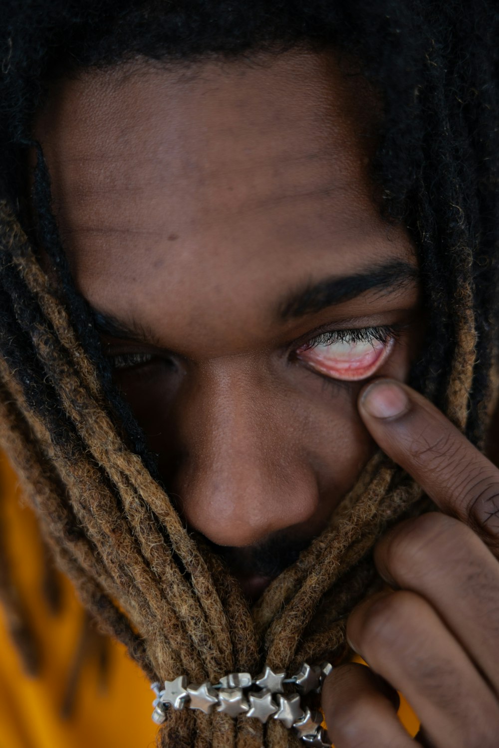a close up of a person with dreadlocks