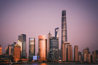 a city skyline with skyscrapers and a body of water