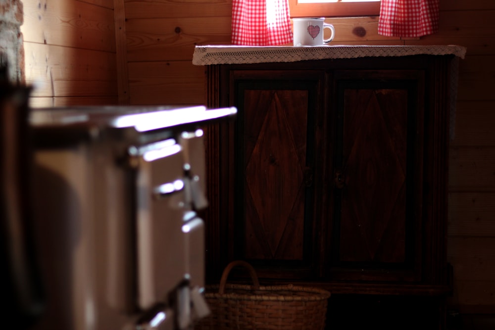 a kitchen area with a cabinet and a window