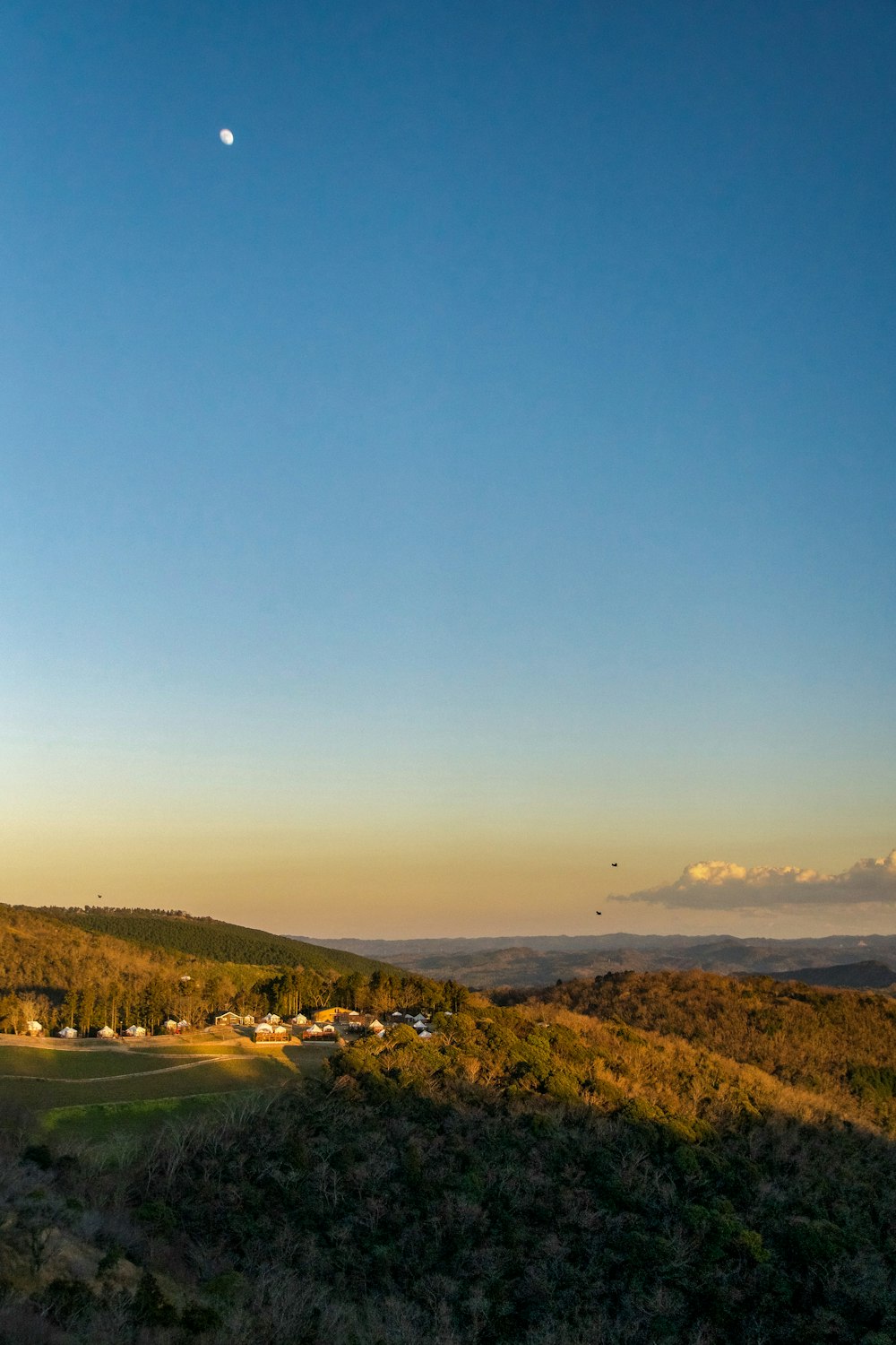 a view of a hill with a small town in the distance