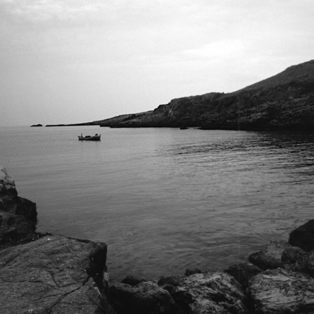 a black and white photo of a boat in the water