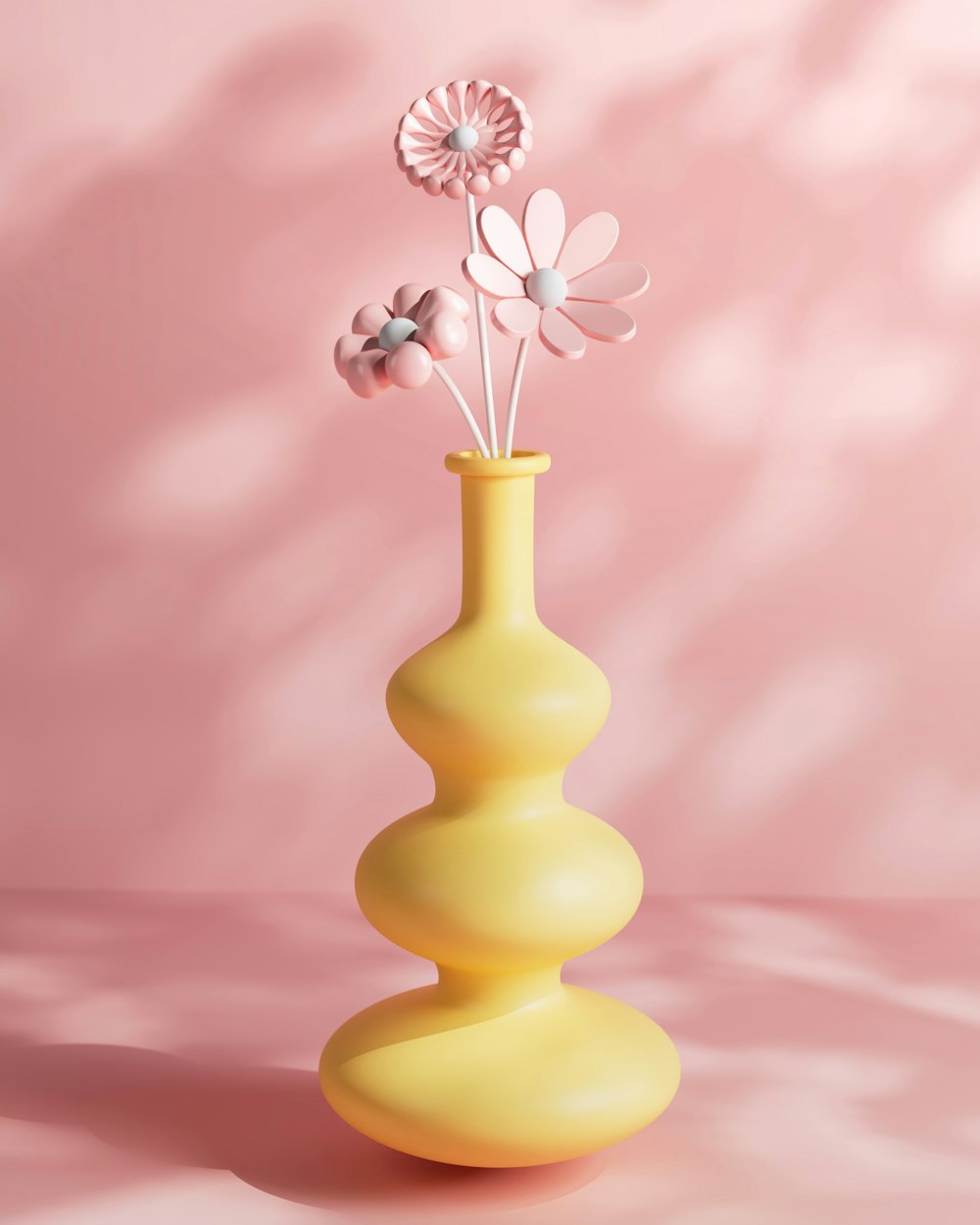 a yellow vase with three flowers in it