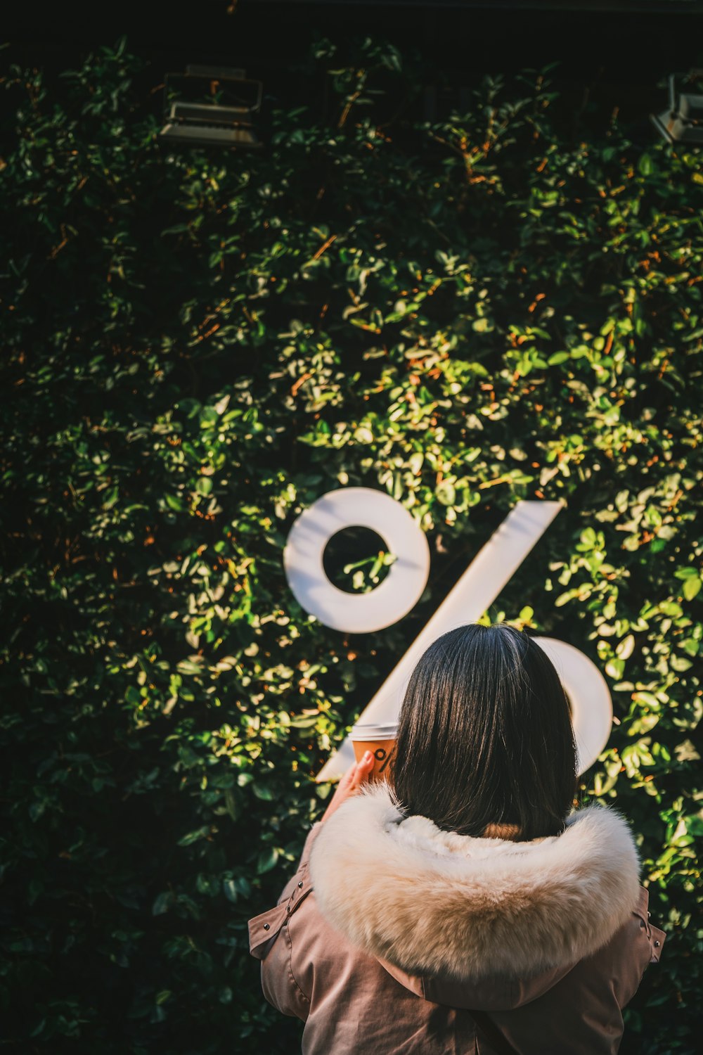 a woman standing in front of a wall with the number six on it