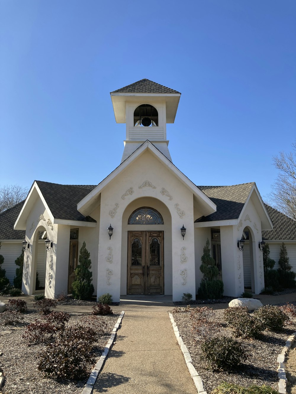 a white church with a clock tower on top of it