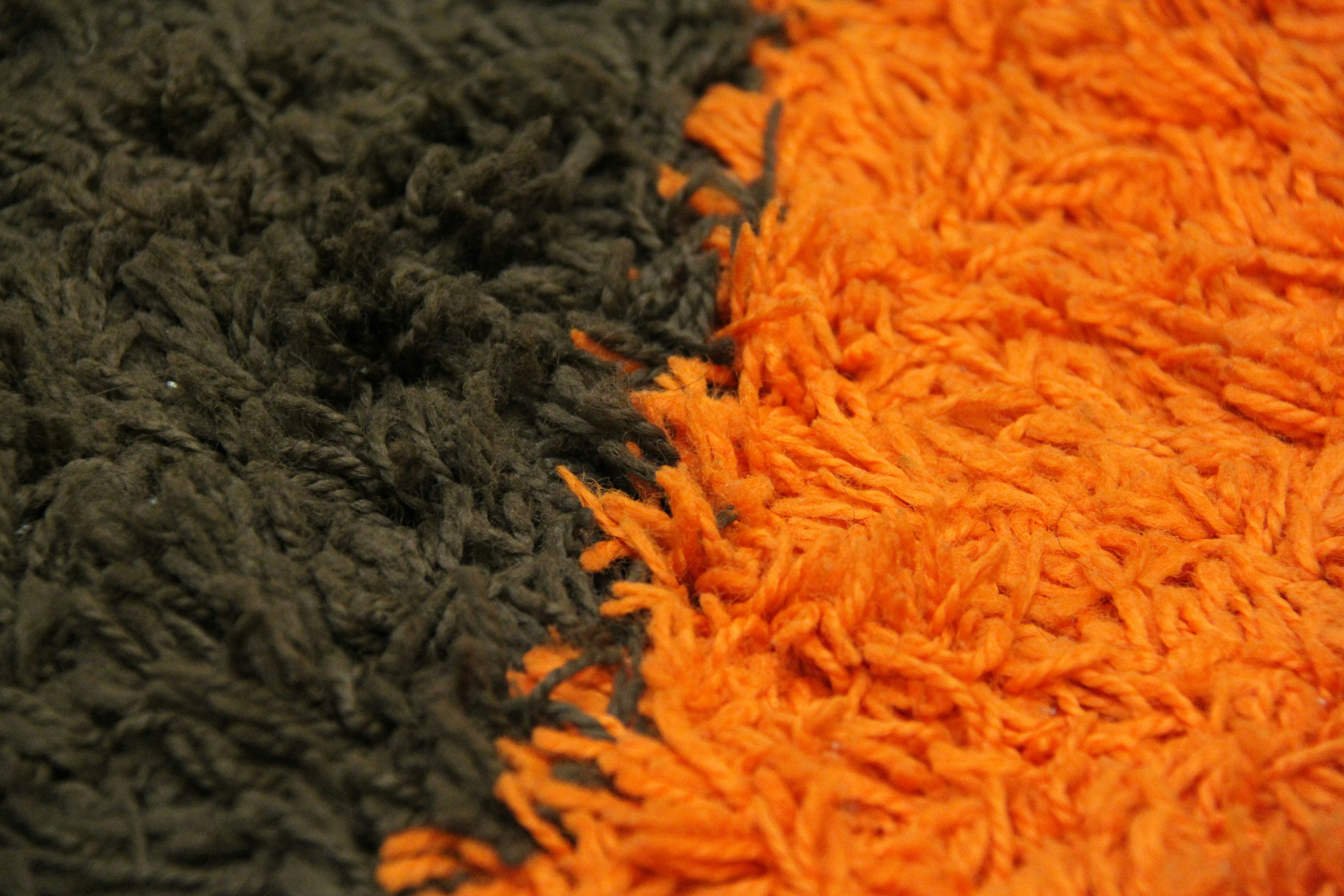 a close up of a black and orange rug