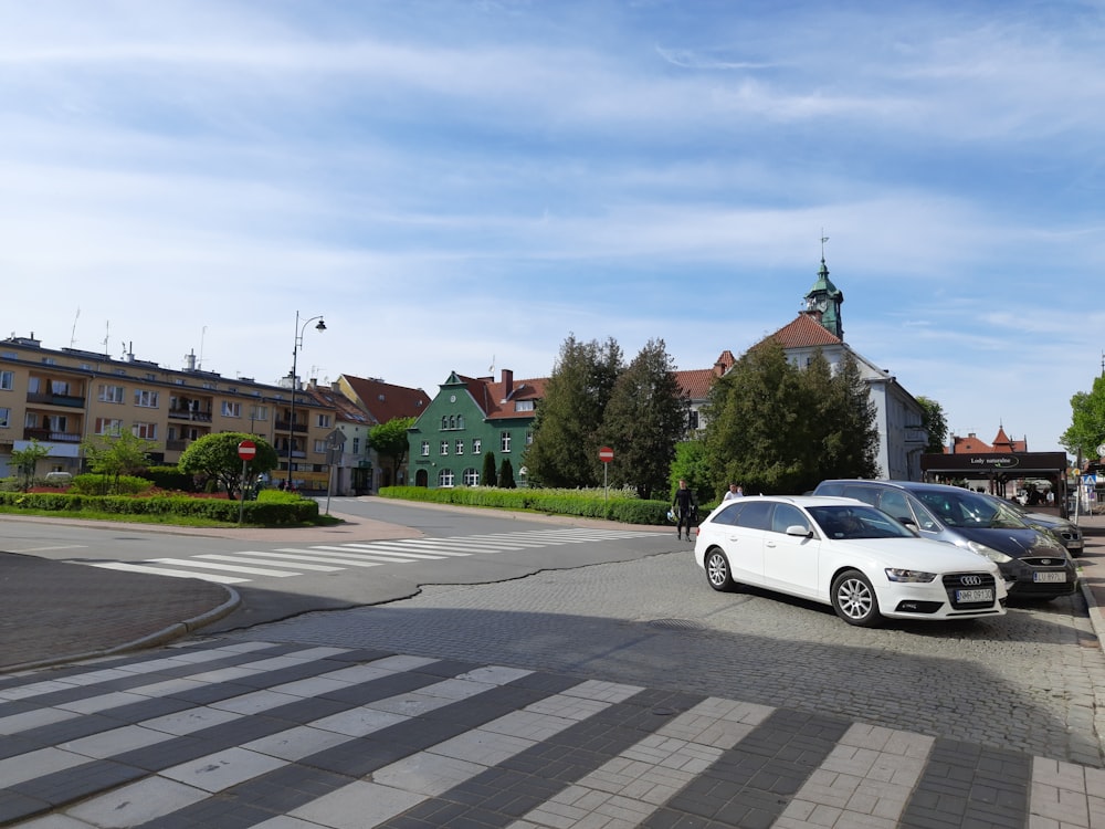 a white car parked on the side of a road