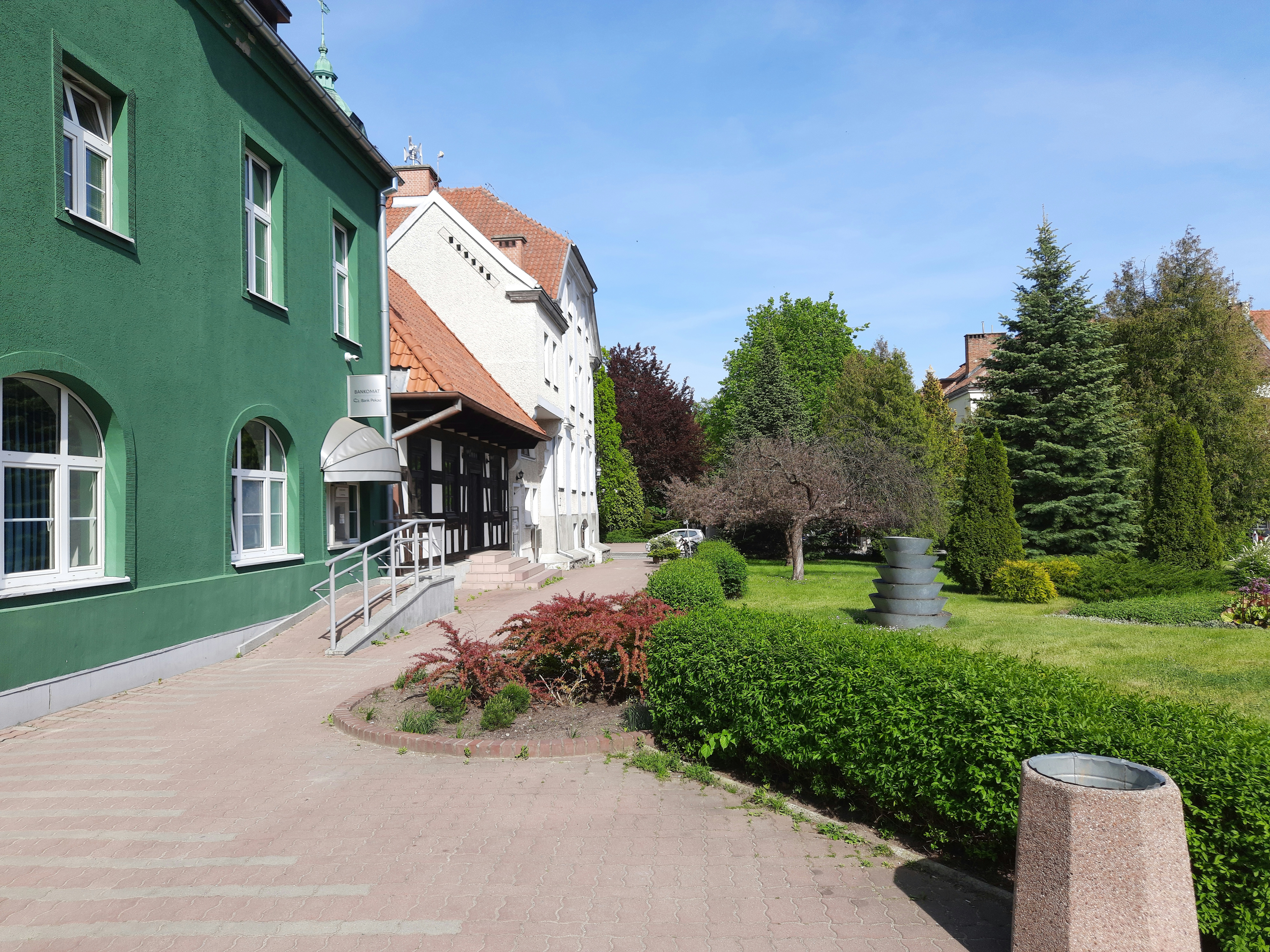 a green building with a walkway leading to it