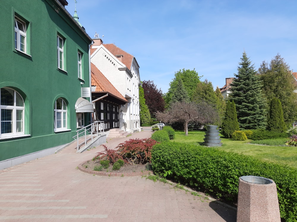 a green building with a walkway leading to it