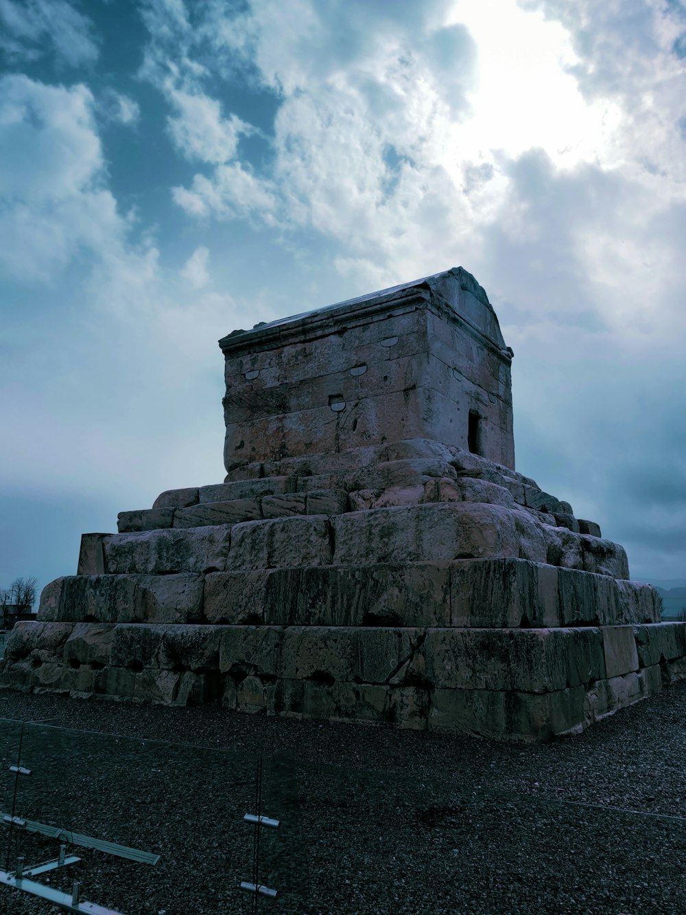 a large stone structure sitting on top of a dirt field