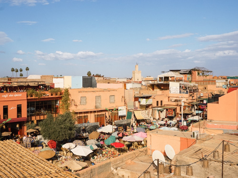 a view of a city with lots of buildings and umbrellas