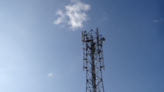 a cell phone tower is shown against a blue sky