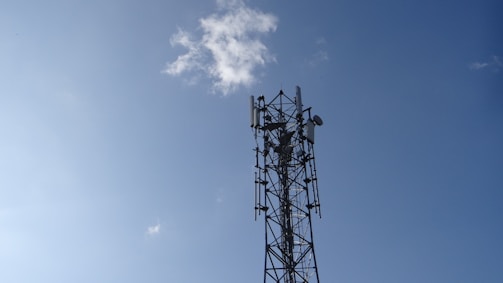 a cell phone tower is shown against a blue sky