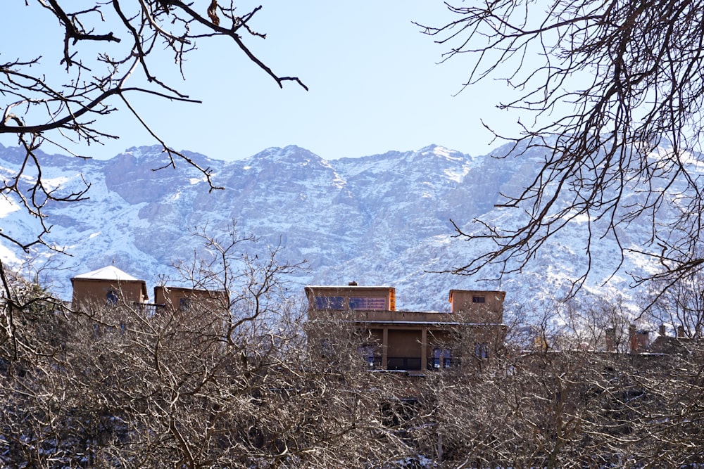 a house in the mountains with snow on the ground