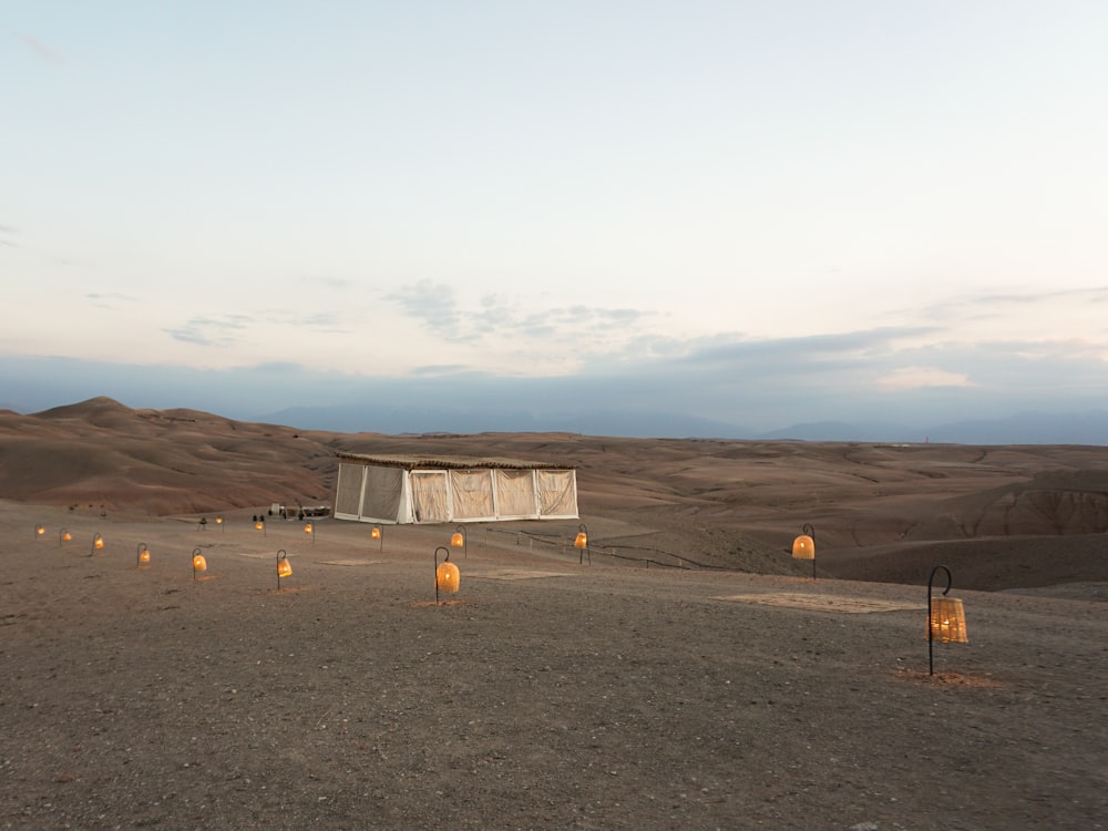 a desert area with several lit candles in the middle of it