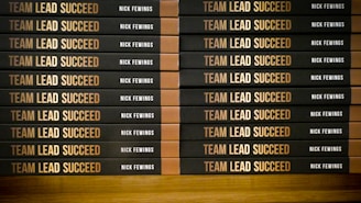 a stack of books sitting on top of a wooden table