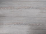 Close-up of fine wood grain details on a modern dark gray kitchen cabinet.