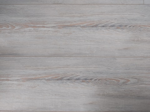 Close-up of fine wood grain details on a modern dark gray kitchen cabinet.