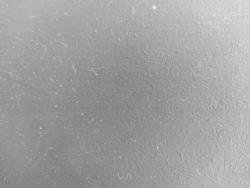a close up of a white wall with small dots on it