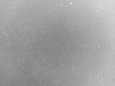 a close up of a white wall with small dots on it