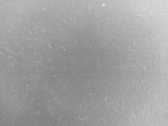 a close up of a white wall with small dots on it