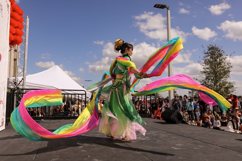a woman in a colorful dress is dancing