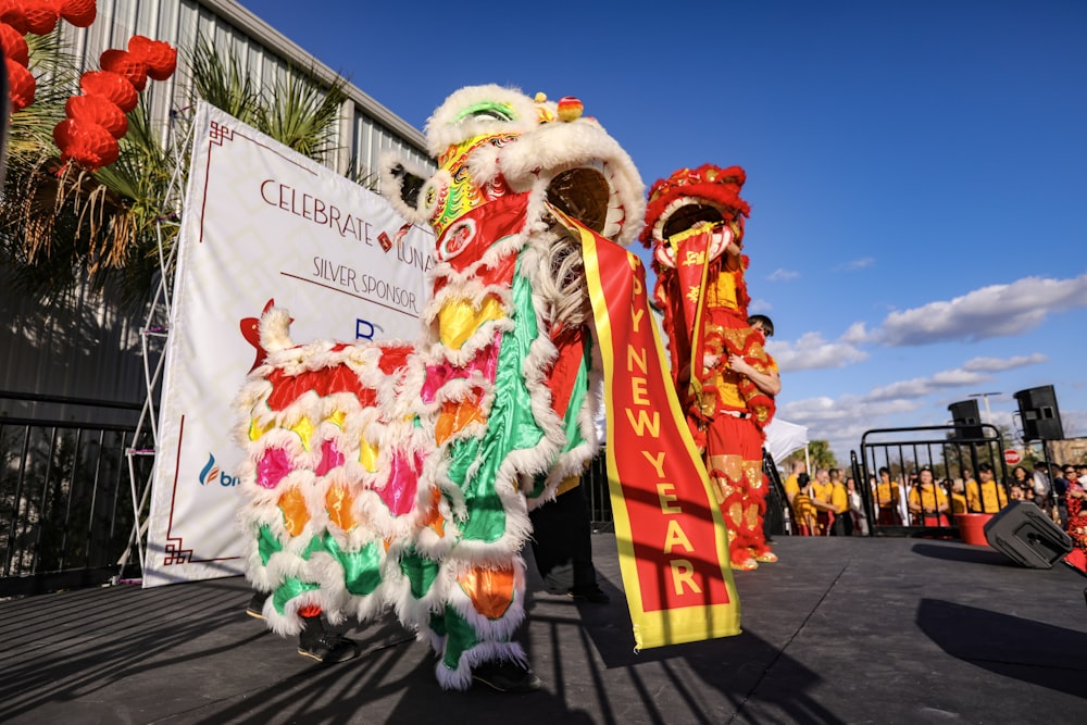 a lion dance is being performed in front of a crowd
