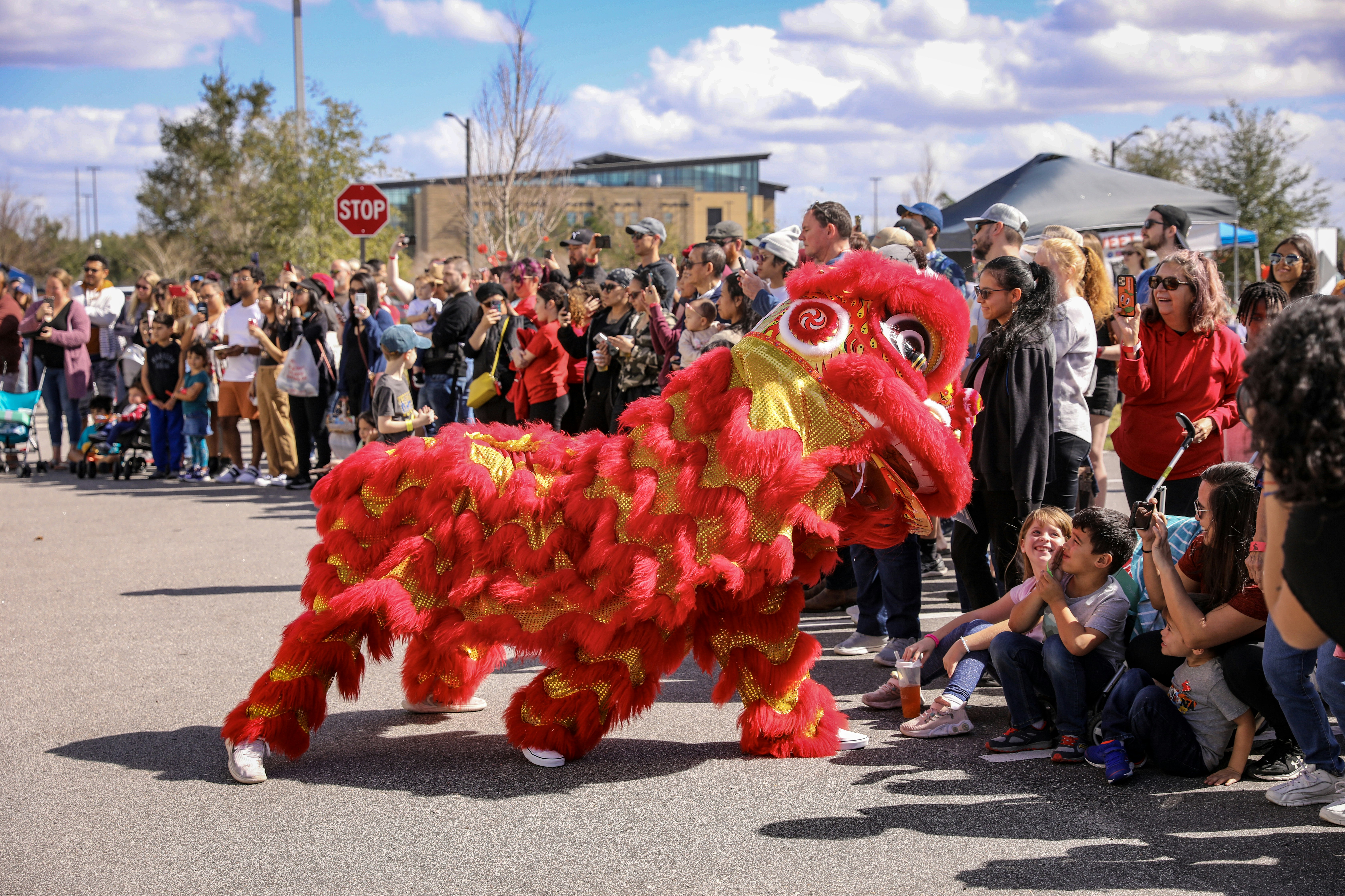 a parade with a red and yellow dragon float