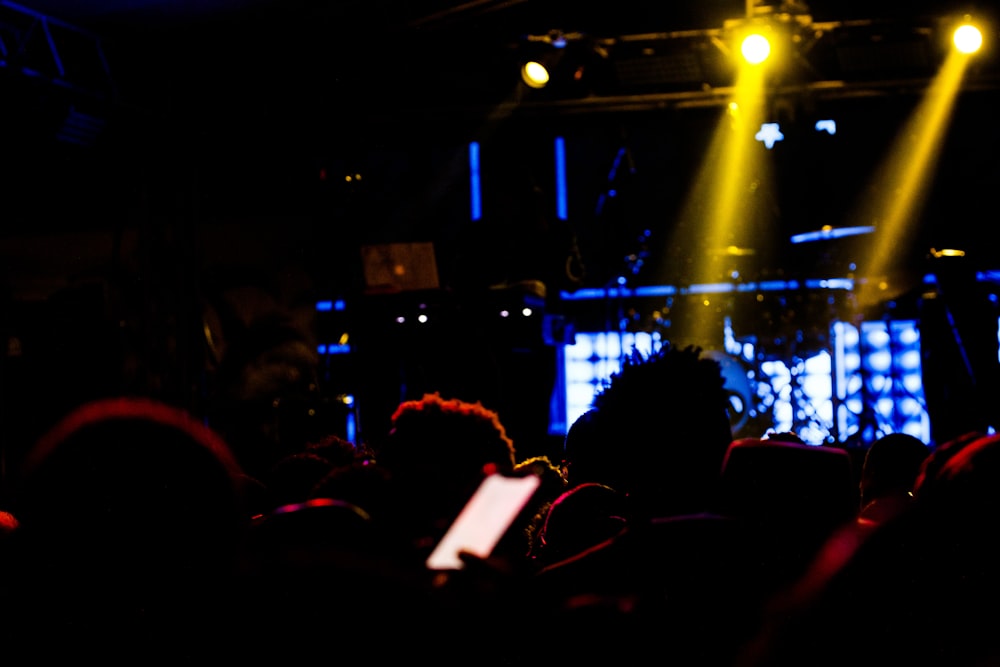 a group of people sitting in front of a stage